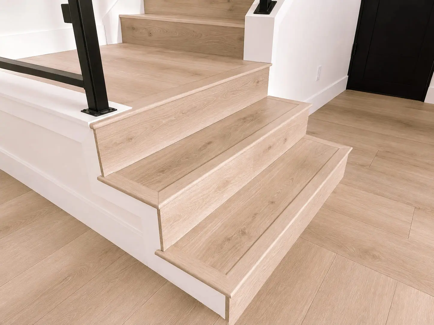 Oak stair treads meeting a landing in the same plank, with the grain direction carried through