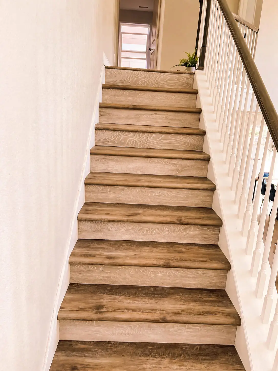 Wood stair flight with consistent riser heights and matched nosings from bottom to top